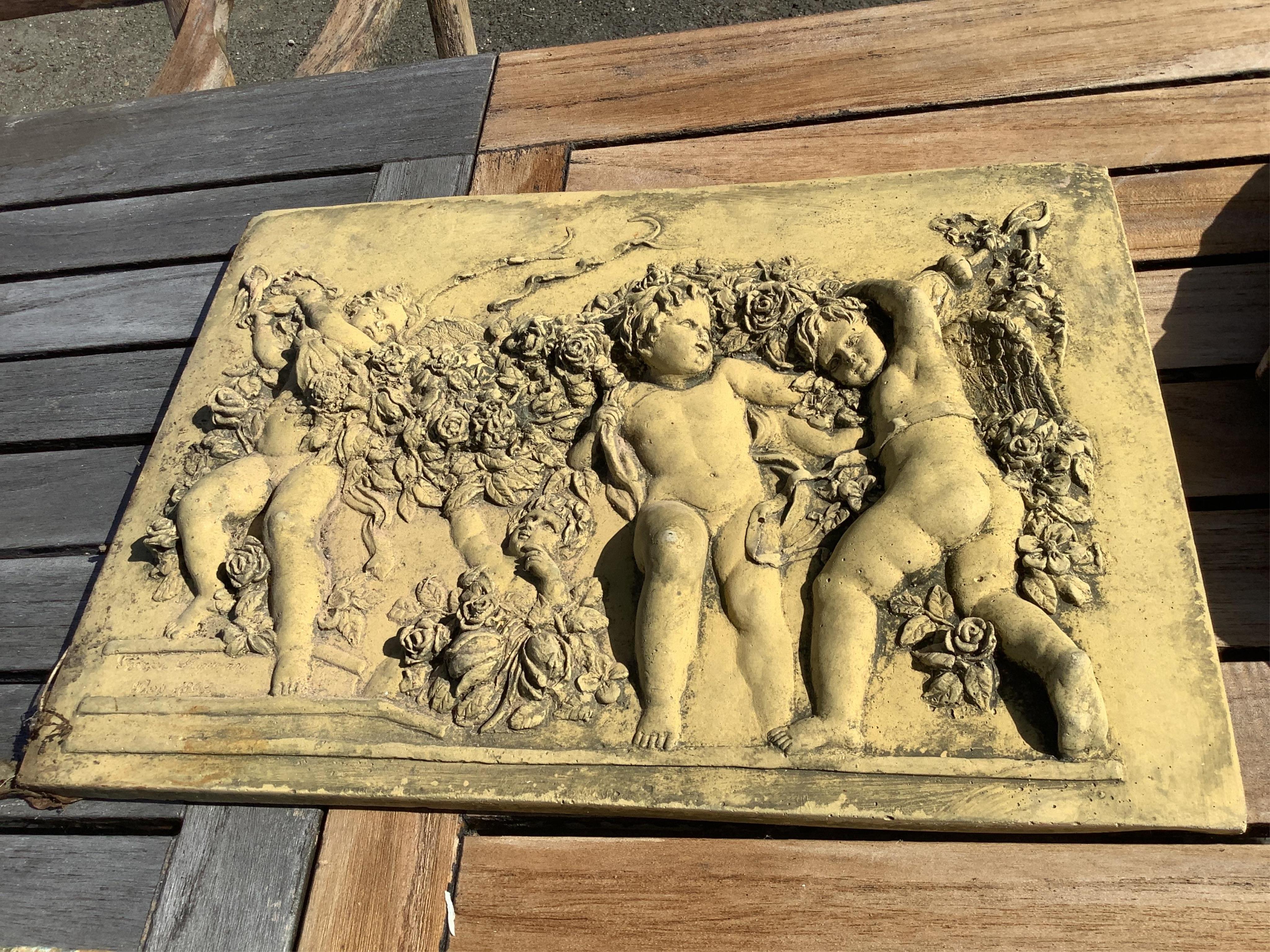 Five cast stone and terracotta garden wall plaques, largest diameter 41cm
